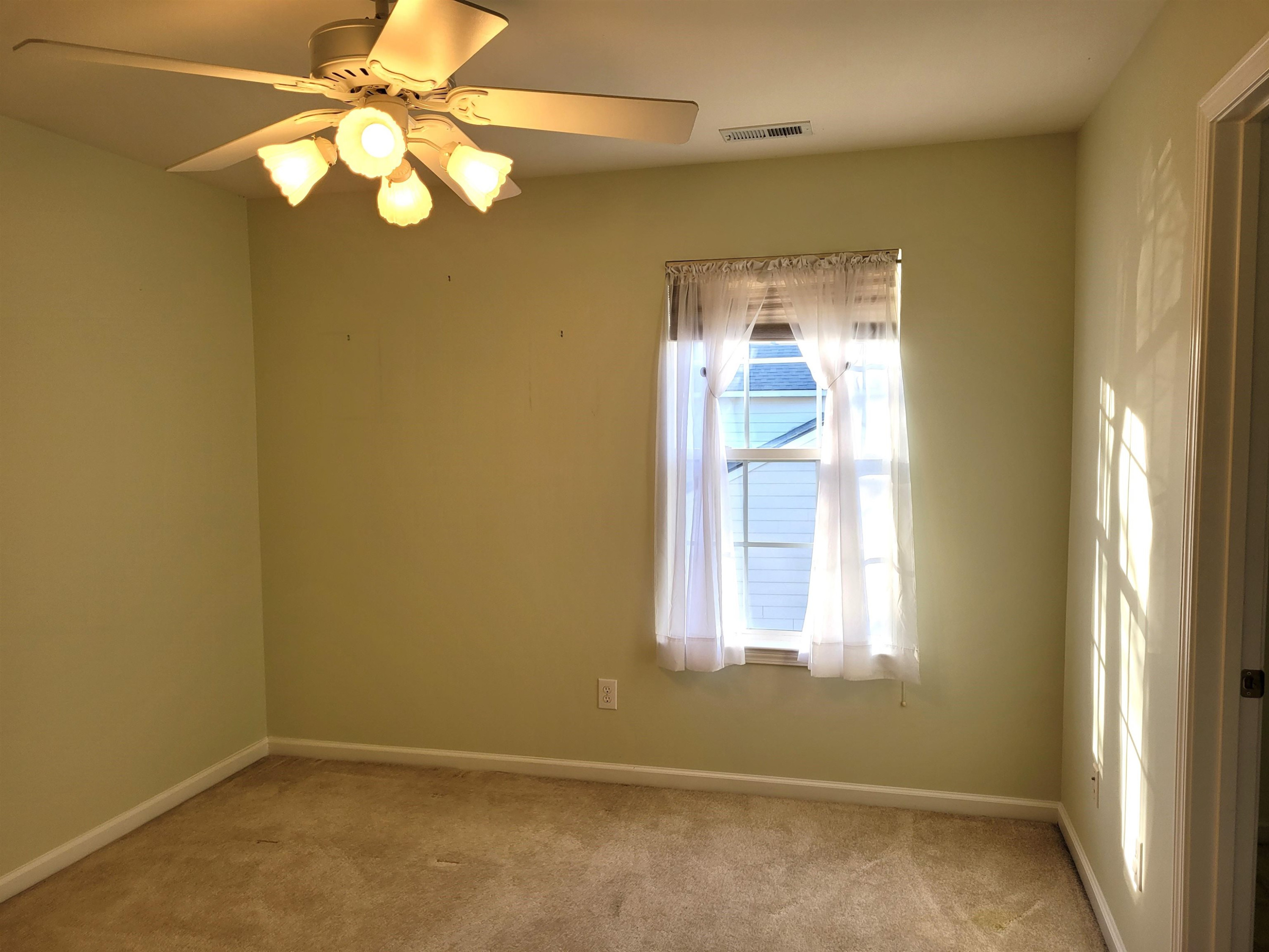 7 Calaveras Court Durham, NC 27713 - Photo 24 of 30 an empty room with a window and a chandelier