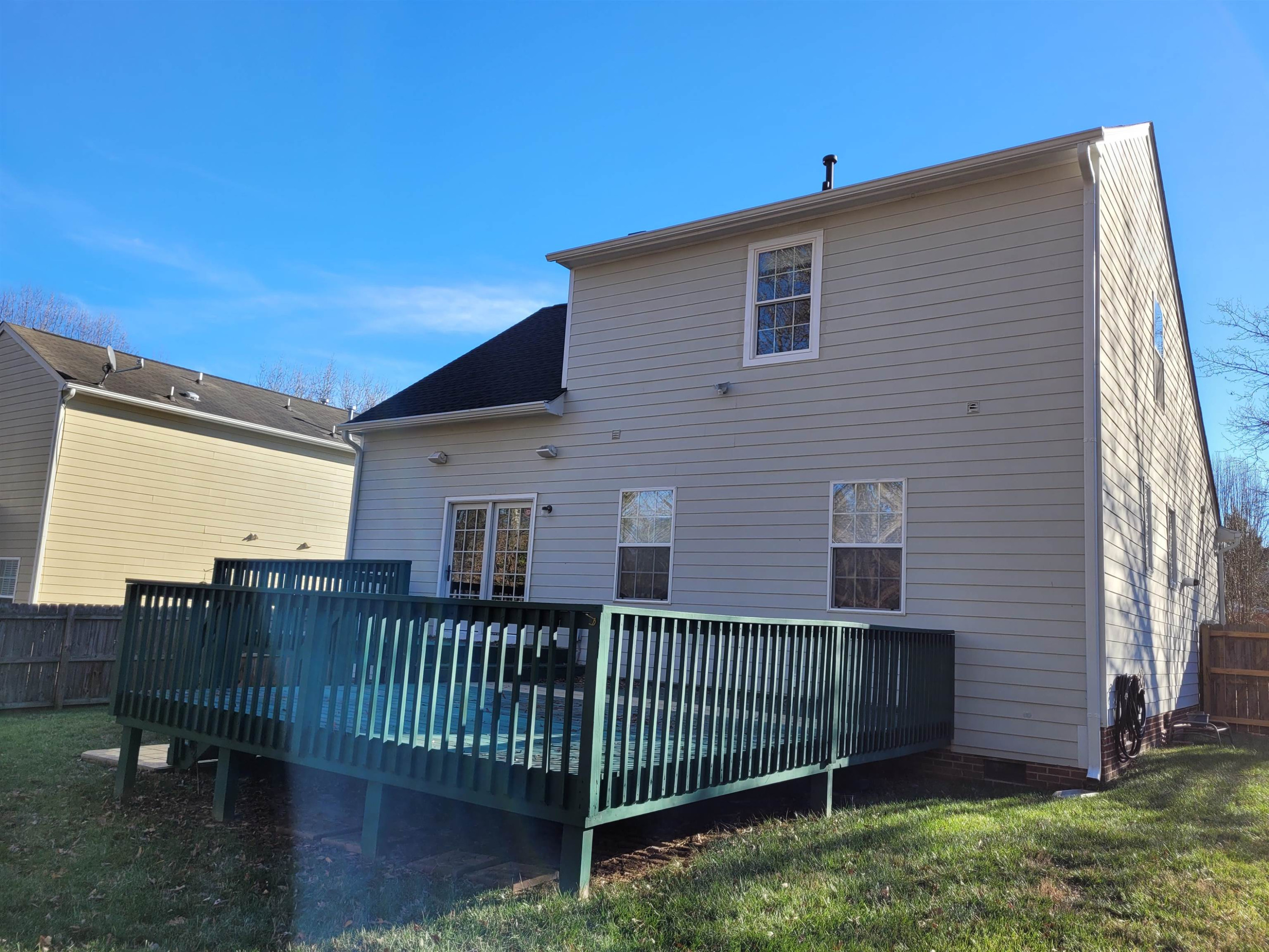 7 Calaveras Court Durham, NC 27713 - Photo 27 of 30 a view of a house with a small yard and wooden fence