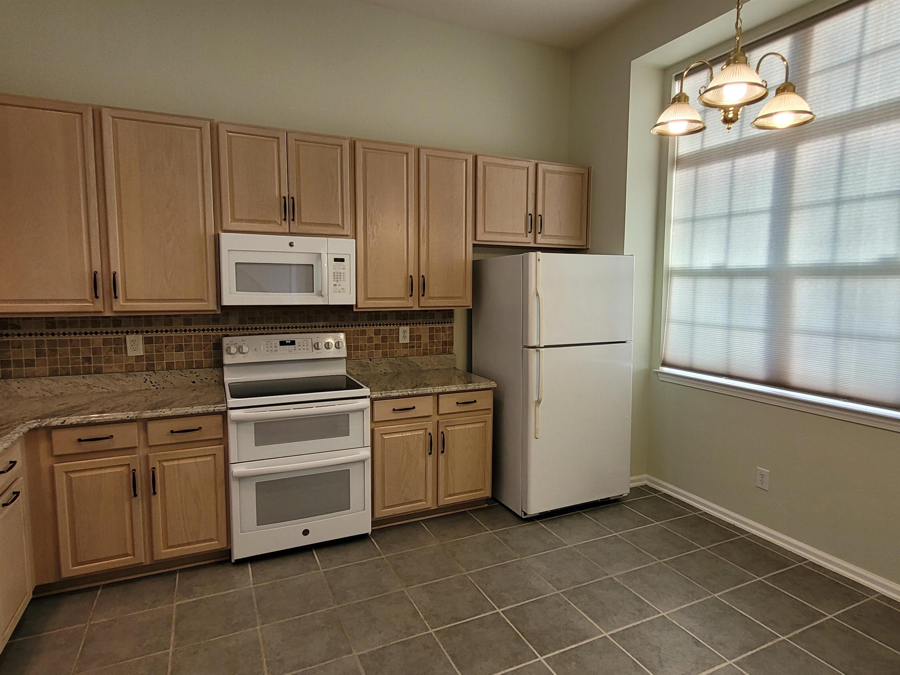 7 Calaveras Court Durham, NC 27713 - Photo 6 of 30 a kitchen with cabinets and white stainless steel appliances