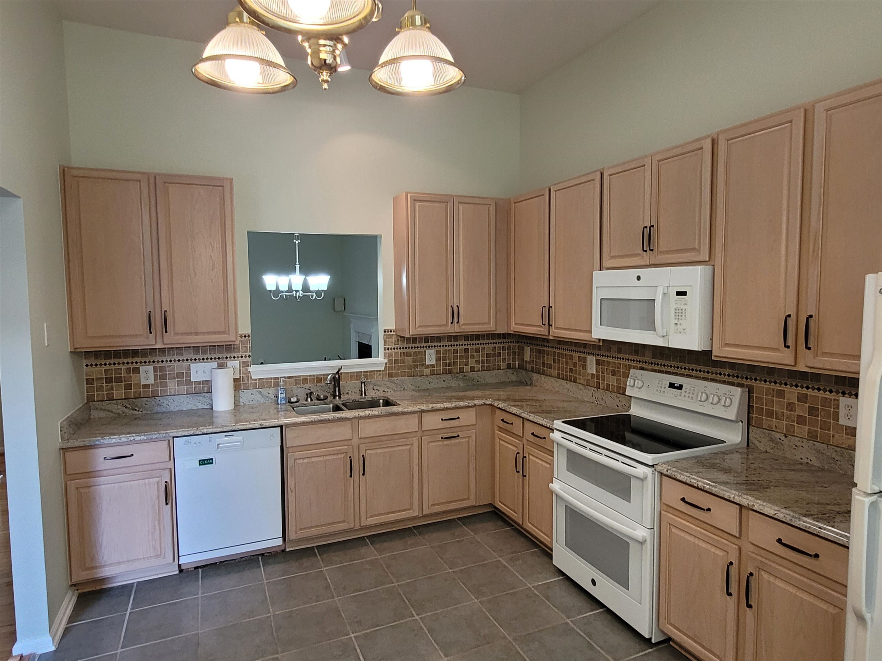 7 Calaveras Court Durham, NC 27713 - Photo 7 of 30 a kitchen with a sink cabinets and stainless steel appliances