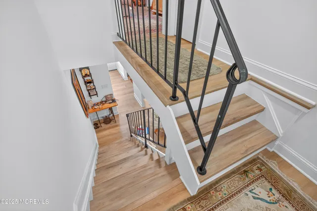 a view of staircase with white walls and a window