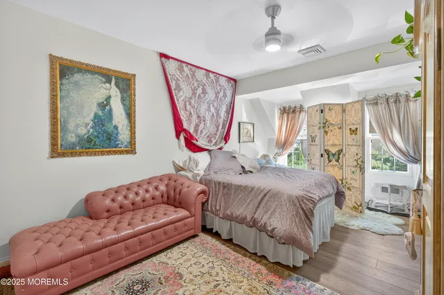 a bedroom with a bed couch and a window