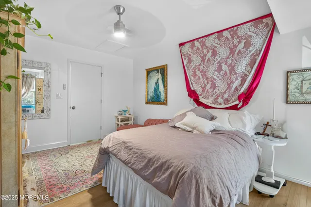 a bedroom with a bed and a painting on the wall