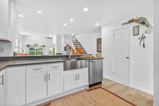 a view of a kitchen with cabinets and wooden floor