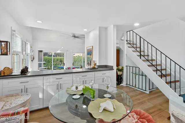 a dining room with furniture a rug and wooden floor