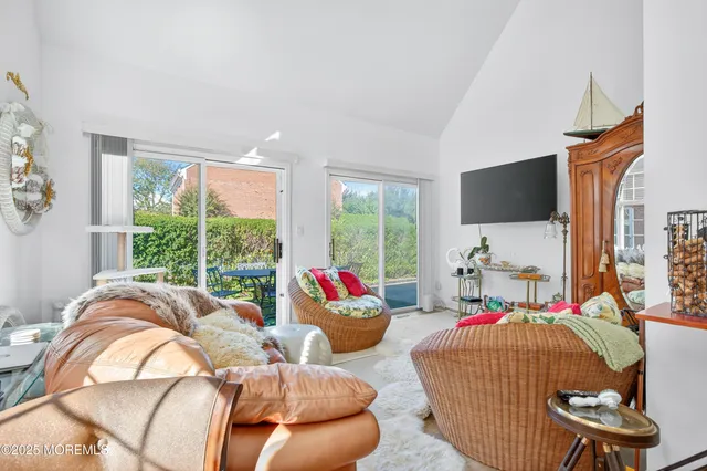 a living room with furniture and a floor to ceiling window