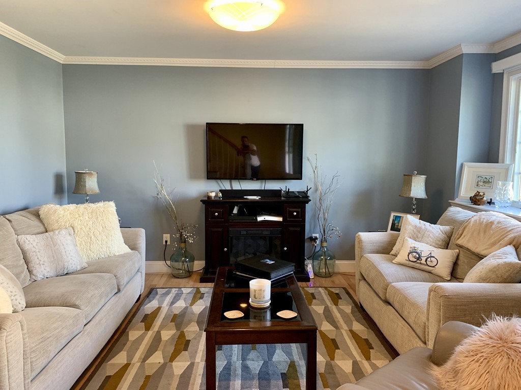 130 Turnpike Road, Unit 13 Chelmsford, MA 01824 - Photo 11 of 35 a living room with furniture and a flat screen tv