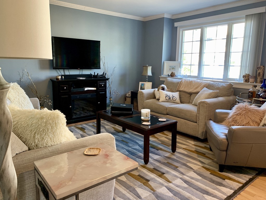 130 Turnpike Road, Unit 13 Chelmsford, MA 01824 - Photo 12 of 35 a living room with furniture and a flat screen tv