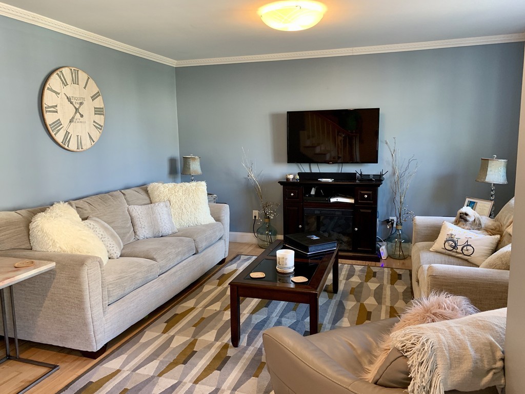 130 Turnpike Road, Unit 13 Chelmsford, MA 01824 - Photo 13 of 35 a living room with furniture a flat screen tv and a window