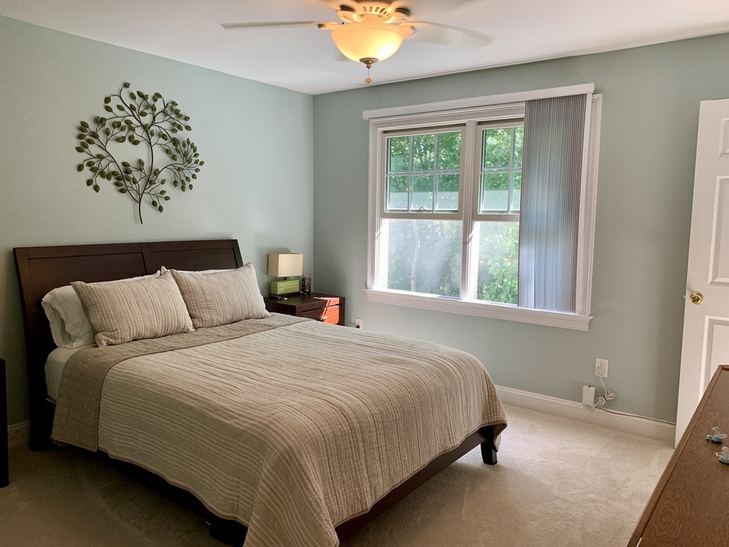 130 Turnpike Road, Unit 13 Chelmsford, MA 01824 - Photo 22 of 35 a bedroom with a bed and a window