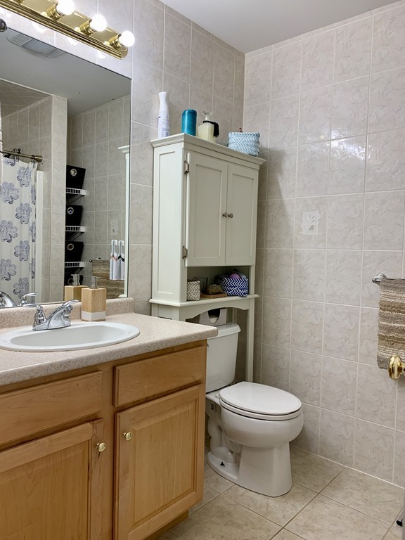 130 Turnpike Road, Unit 13 Chelmsford, MA 01824 - Photo 27 of 35 a bathroom with a toilet sink and mirror