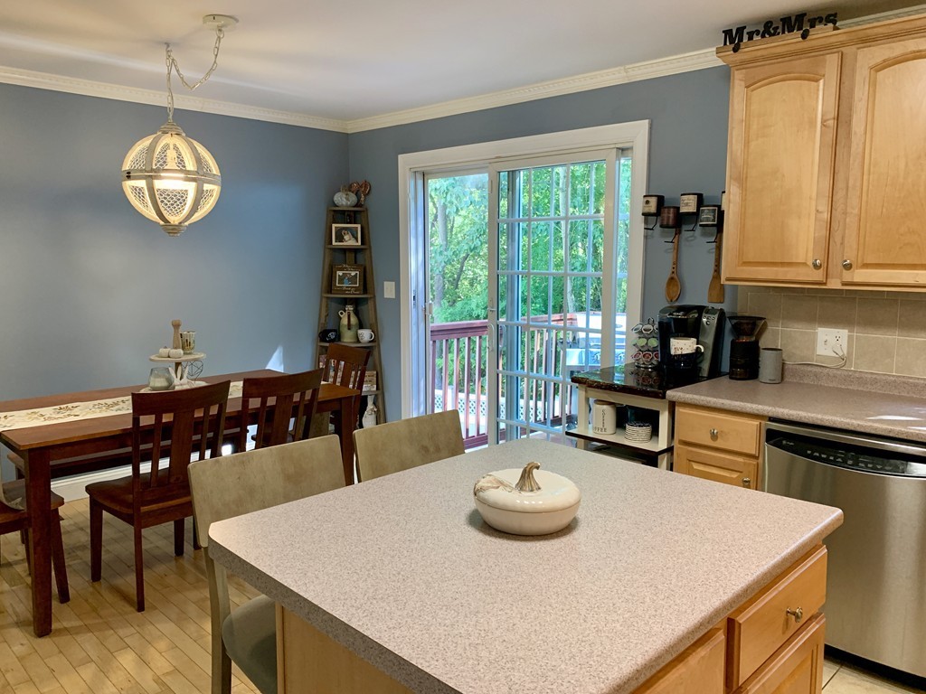 130 Turnpike Road, Unit 13 Chelmsford, MA 01824 - Photo 4 of 35 a view of a dining table and chairs in the kitchen