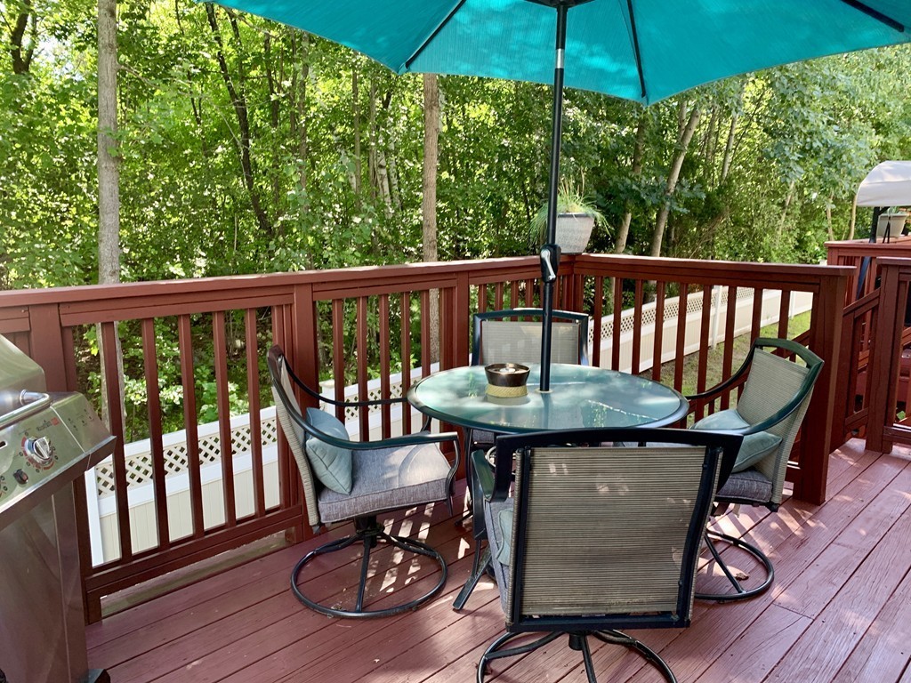 130 Turnpike Road, Unit 13 Chelmsford, MA 01824 - Photo 8 of 35 a view of balcony with furniture and umbrella
