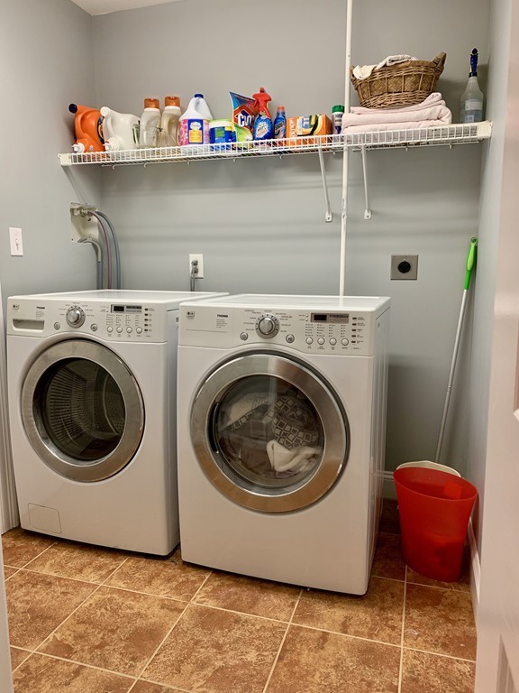 130 Turnpike Road, Unit 13 Chelmsford, MA 01824 - Photo 10 of 35 a utility room with a wooden floor and shelf