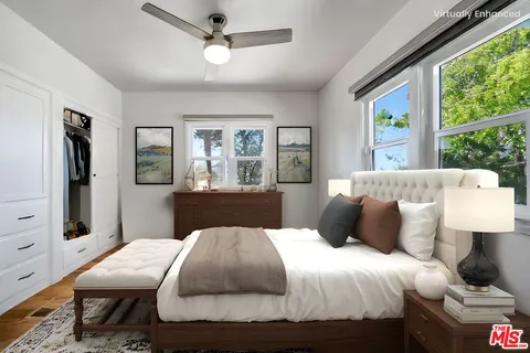 a bedroom with a large bed and a window