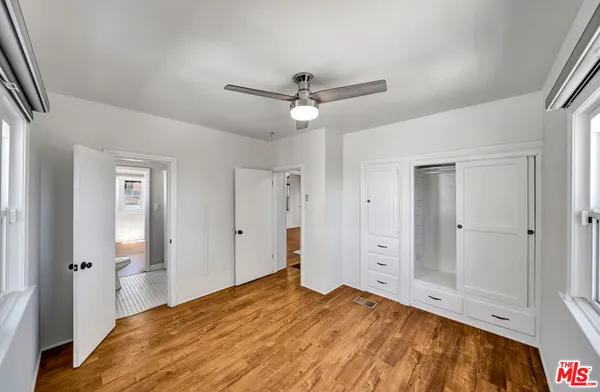 a bedroom with a large bed and closet