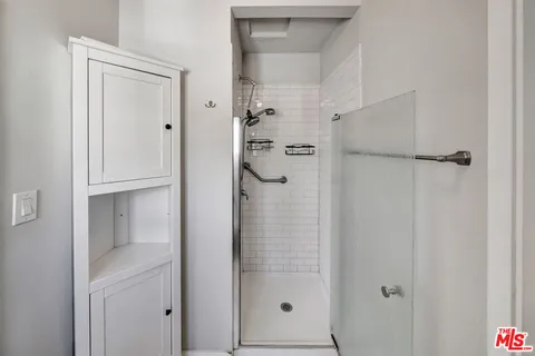 a bathroom with a glass shower door