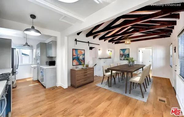 a view of a dining room with furniture and wooden floor