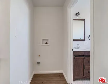 a bathroom with a sink a toilet a mirror and shower