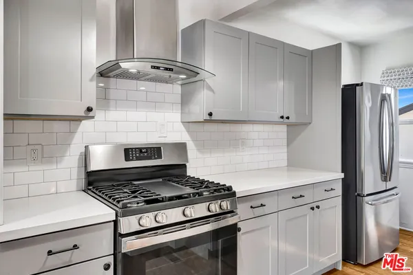 a stove top oven sitting inside of a kitchen