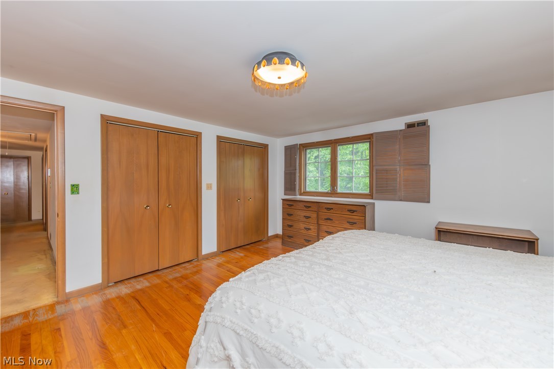 25001 Letchworth Road Beachwood, OH 44122 - Photo 35 of 50 Hardwood flooring extends throughout this room, featuring two sets of bi-fold closet doors