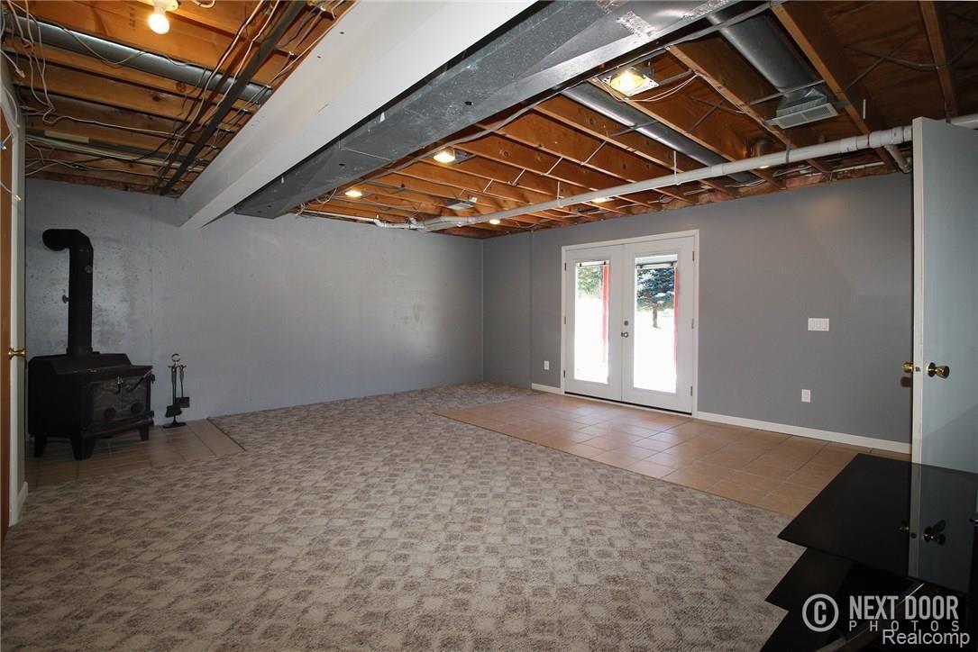 768 Hemingway Road Lake Orion, MI 48362 - Photo 32 of 53 Lower Level Rec Room with Wood Burning Stove leading to Patio.