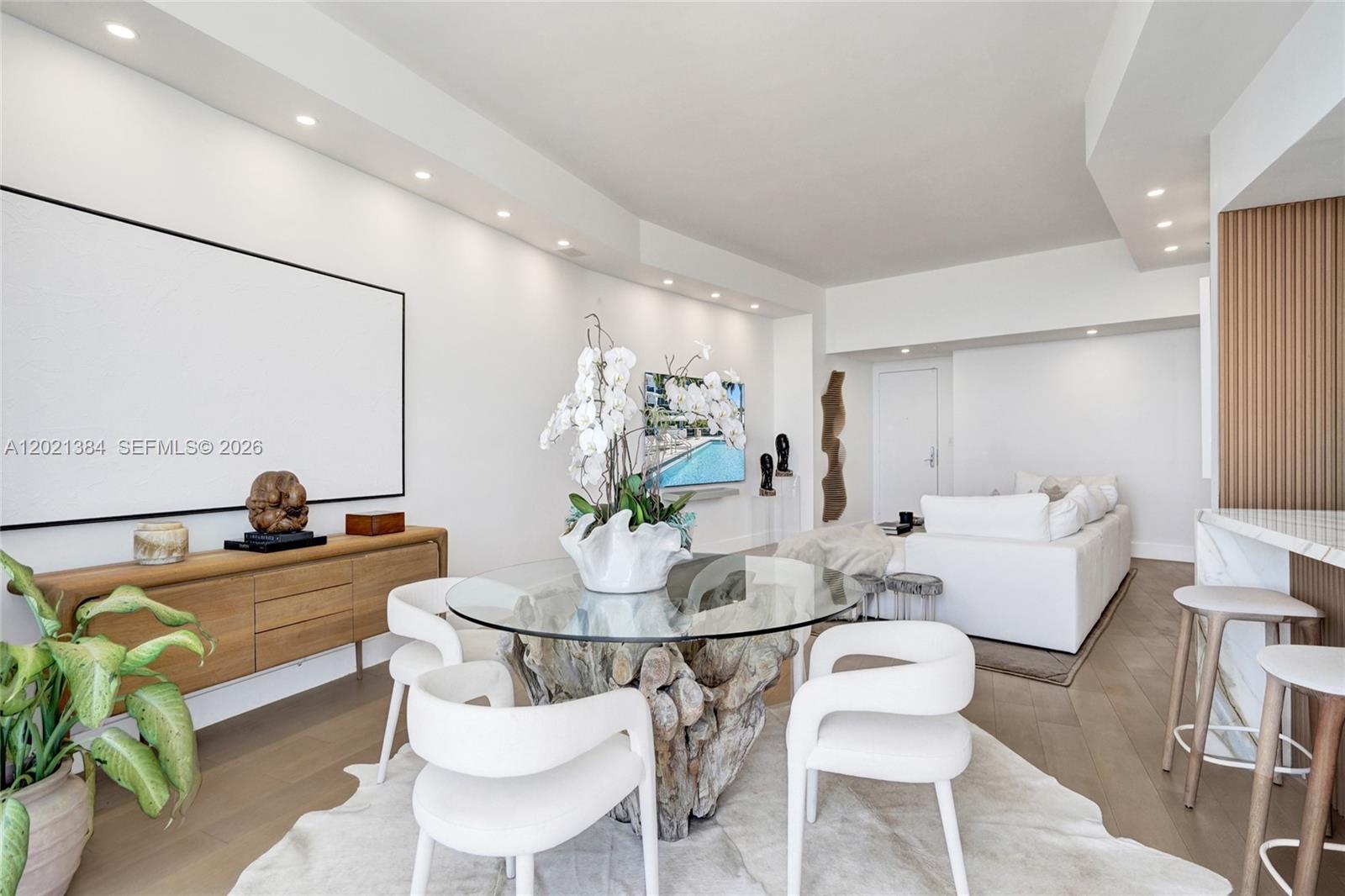 400 Alton Road, Unit PH11 Miami Beach, FL 33139 - Photo 18 of 49 a view of a dining room with furniture and wooden floor