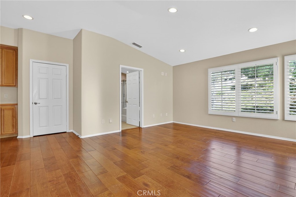 20543 Pesaro Porter Ranch Porter Ranch, CA 91326 - Photo 35 of 67 a view of an empty room with wooden floor and a window