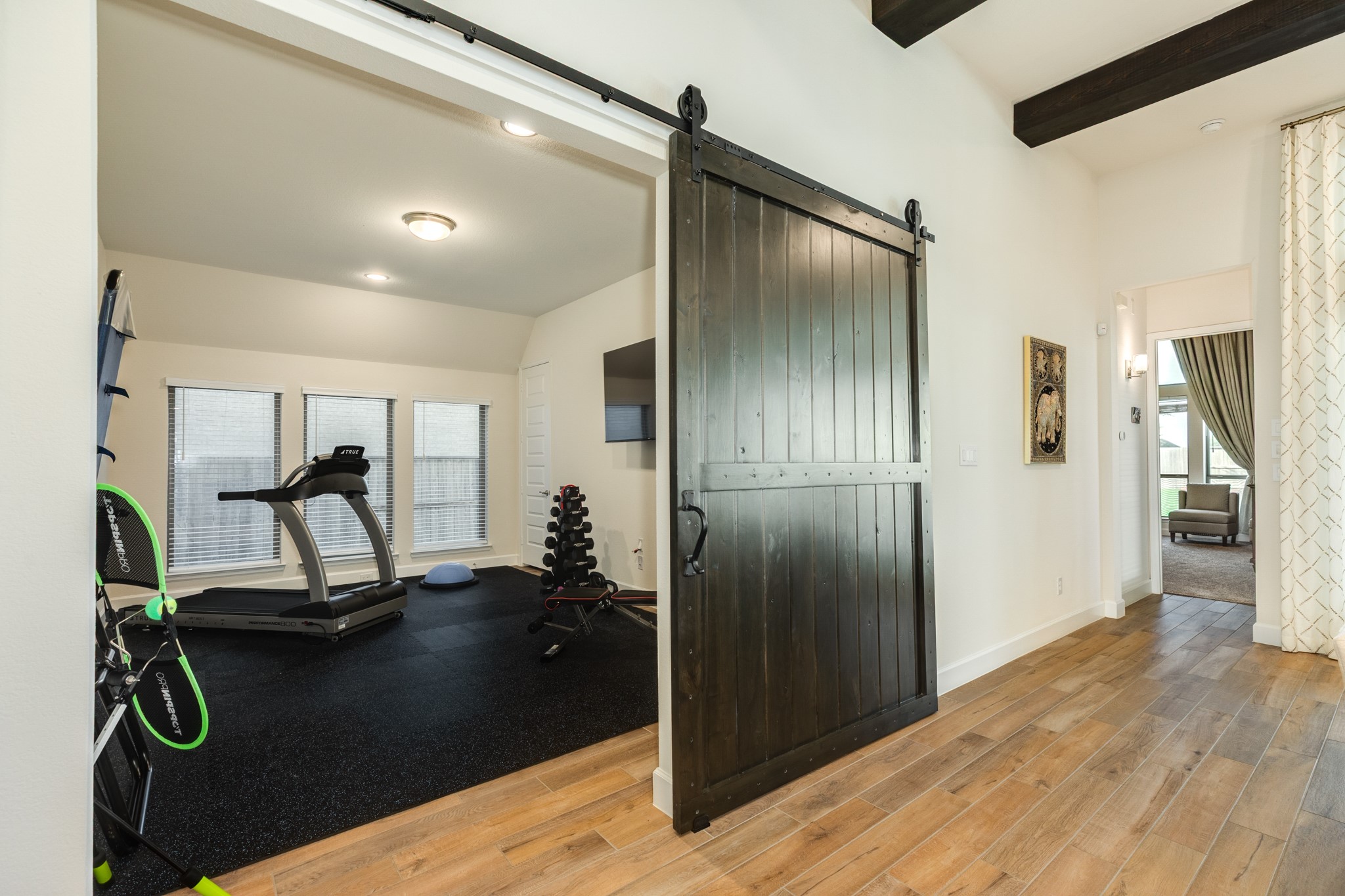 9538 Sanger Way Manvel, TX 77578 - Photo 23 of 50 Spacious game room featuring beautiful tile flooring, recessed lighting, and an abundance of natural light through large windows. Currently utilized as a home gym, this versatile space offers endless possibilities to suit your lifestyle needs.