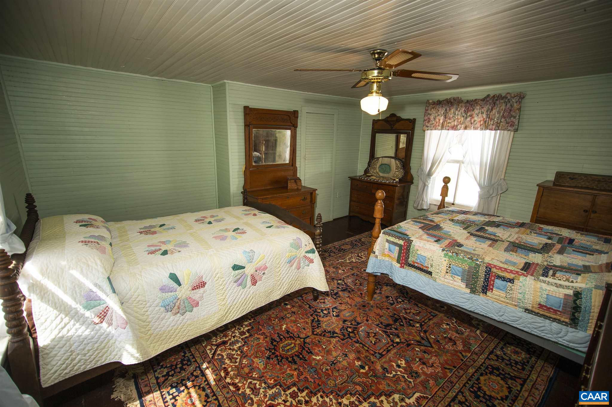 145 Turkey Way Amherst, VA 24521 - Photo 19 of 39 a bedroom with a bed and a chandelier