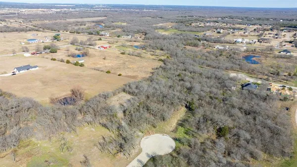 an aerial view of a houses with a yard