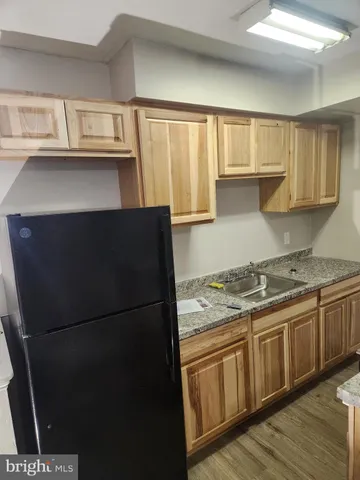 a kitchen with stainless steel appliances granite countertop a refrigerator and a stove