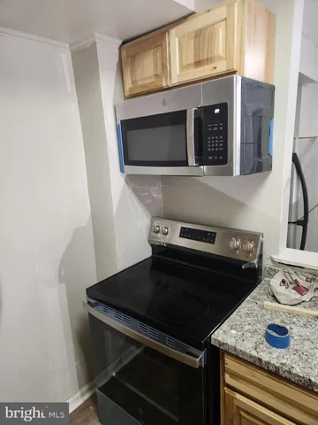 a close view of a stove and microwave