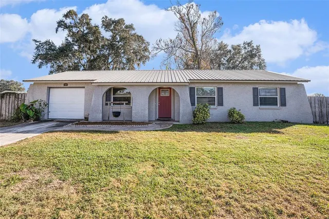 a view of a white house with a yard