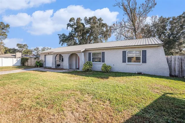 a house view with swimming pool in front of it