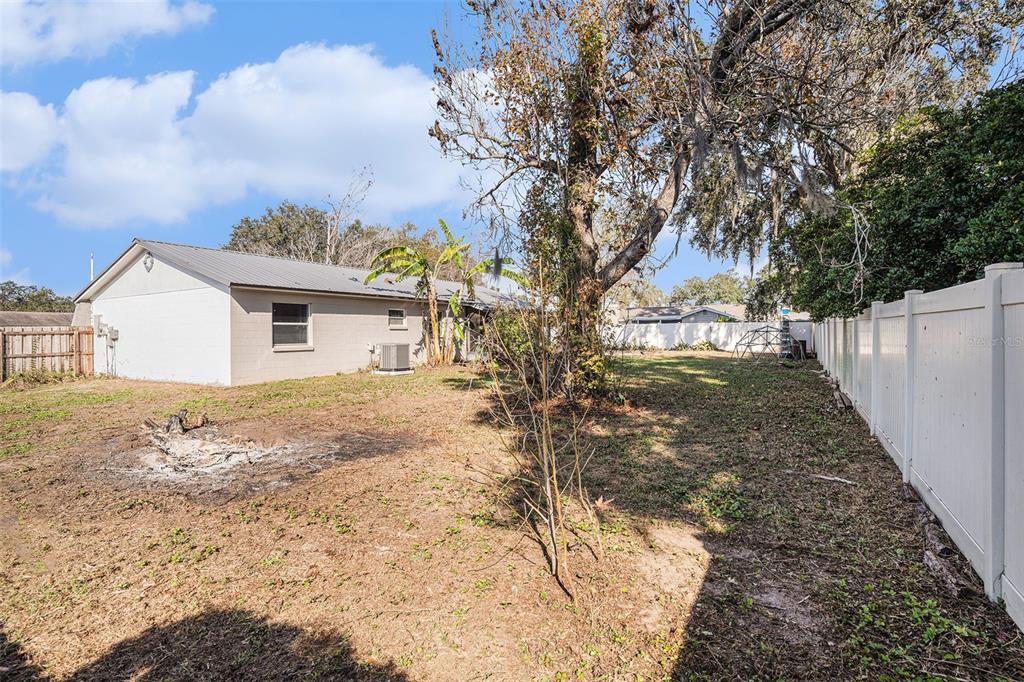 909 Silver Ridge Way Valrico, FL 33594 - Photo 14 of 15 a view of a yard with a tree