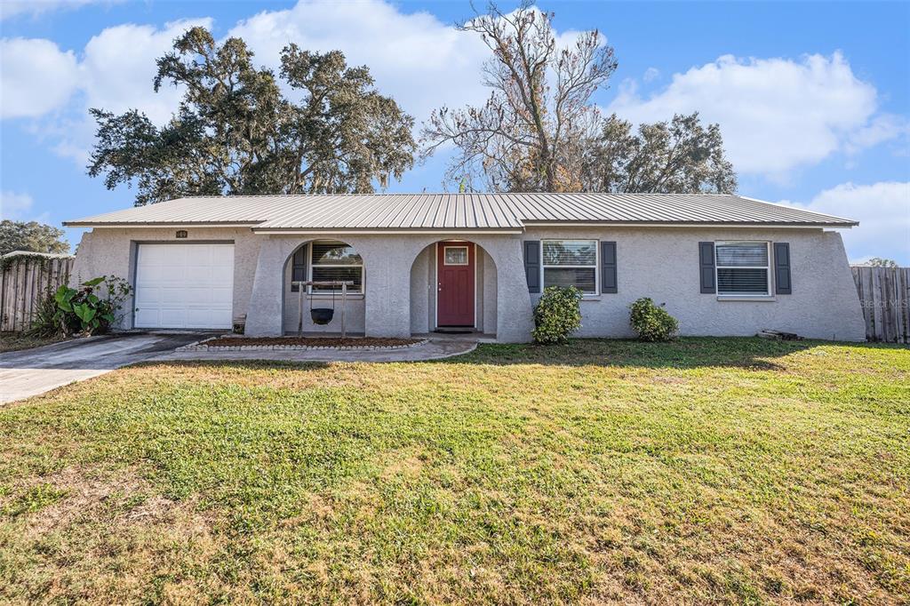909 Silver Ridge Way Valrico, FL 33594 - Photo 2 of 15 a view of a white house with a yard
