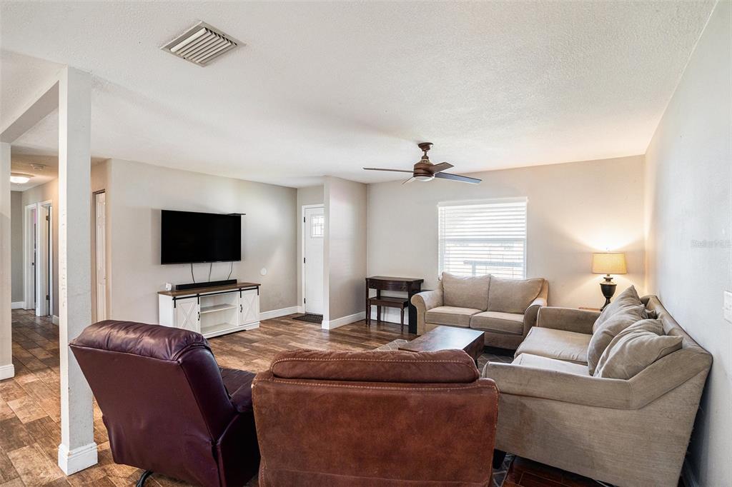 909 Silver Ridge Way Valrico, FL 33594 - Photo 4 of 15 a living room with furniture and a flat screen tv