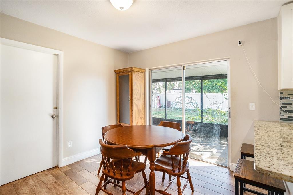 909 Silver Ridge Way Valrico, FL 33594 - Photo 6 of 15 a view of a dining room with furniture and wooden floor
