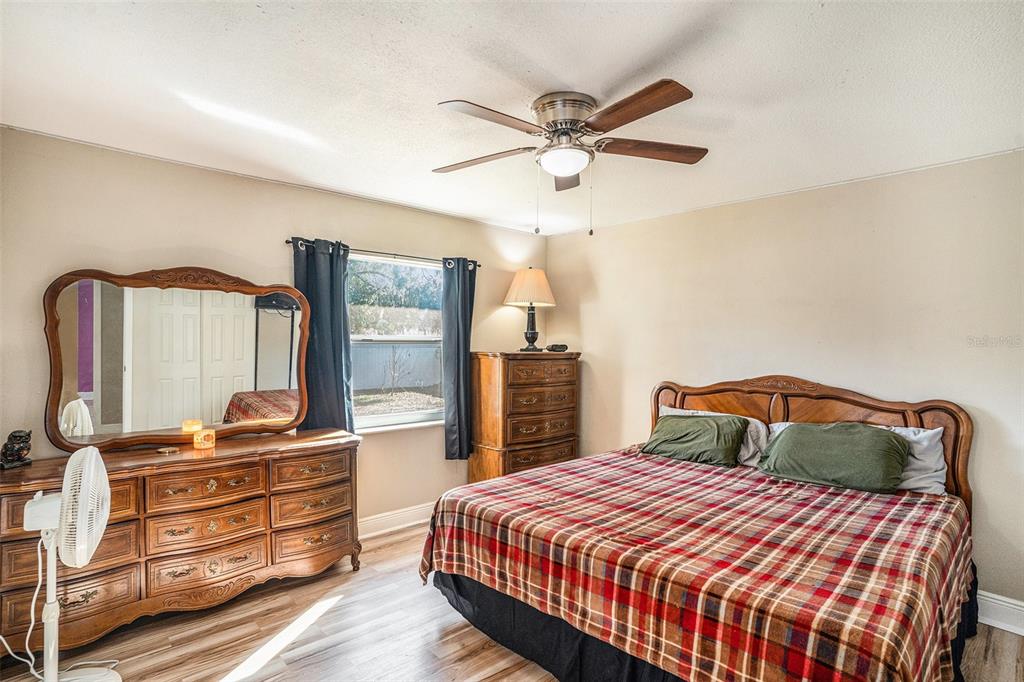 909 Silver Ridge Way Valrico, FL 33594 - Photo 7 of 15 a bedroom with a bed and wooden floor