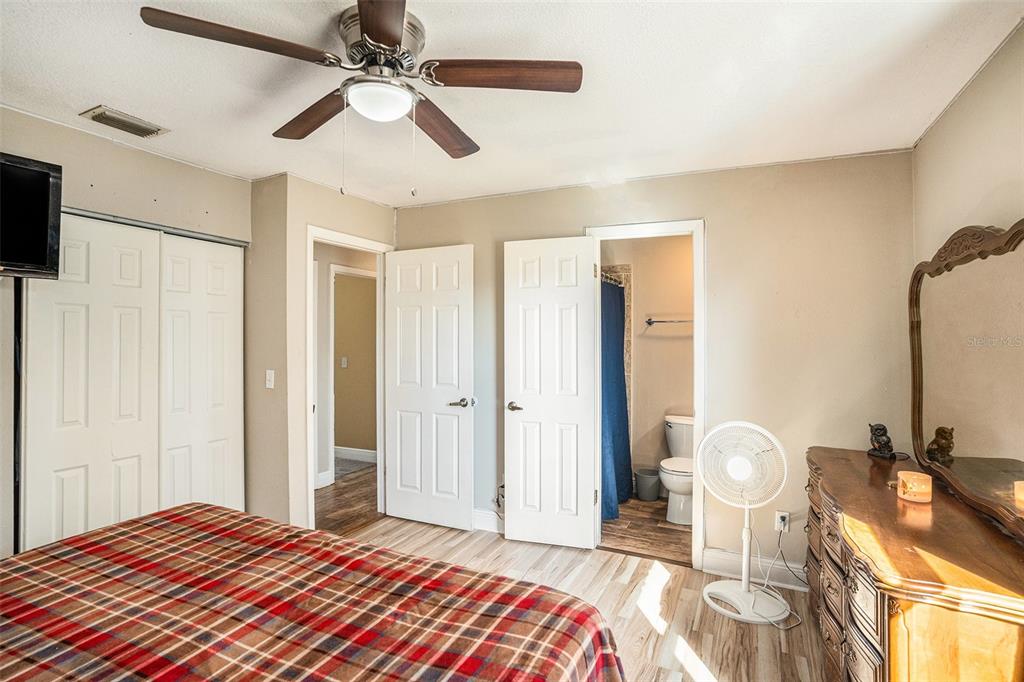 909 Silver Ridge Way Valrico, FL 33594 - Photo 8 of 15 a bedroom with a bed and a chandelier