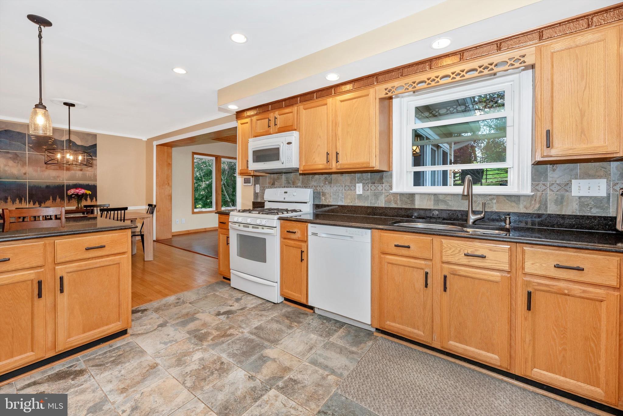 19605 Charline Manor Road Olney, MD 20832 - Photo 11 of 54 a kitchen with stainless steel appliances granite countertop a stove a sink and a refrigerator