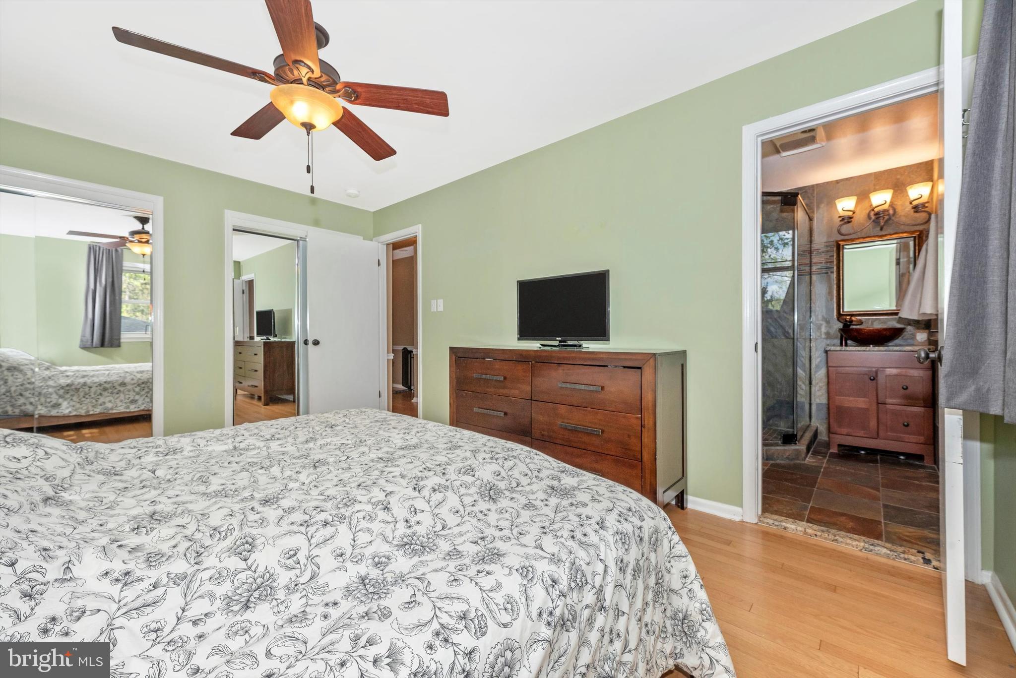 19605 Charline Manor Road Olney, MD 20832 - Photo 15 of 54 a bedroom with a bed and a flat screen tv