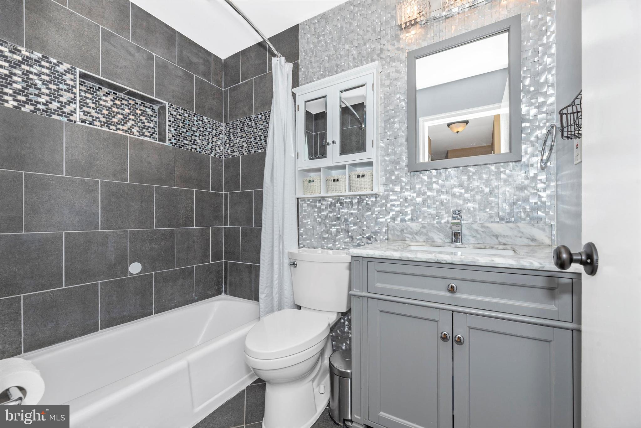 19605 Charline Manor Road Olney, MD 20832 - Photo 21 of 54 a bathroom with a sink a toilet and bathtub