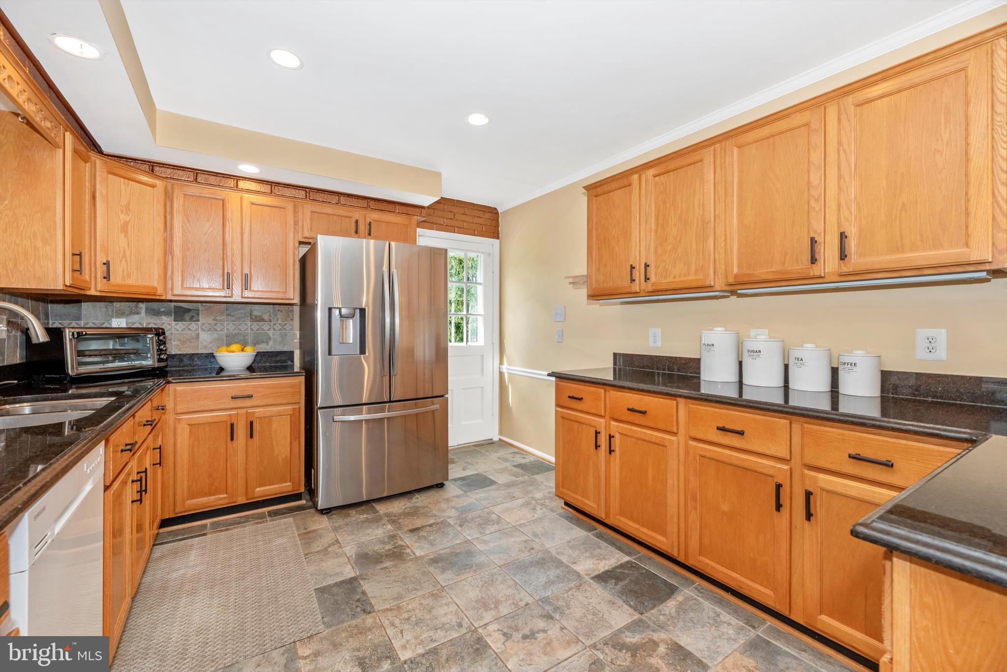 19605 Charline Manor Road Olney, MD 20832 - Photo 9 of 54 a kitchen with stainless steel appliances granite countertop a refrigerator sink and cabinets