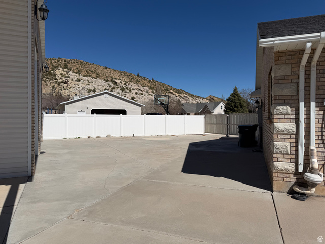 1697 West 2450 Vernal, UT 84078 - Photo 26 of 36 Fenced backyard featuring a mountain view and a patio area