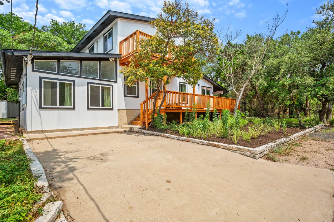 3904 Highland Drive Austin, TX 78734 - Photo 1 of 37 Back of property featuring a patio area, a wooden deck, and stairway
