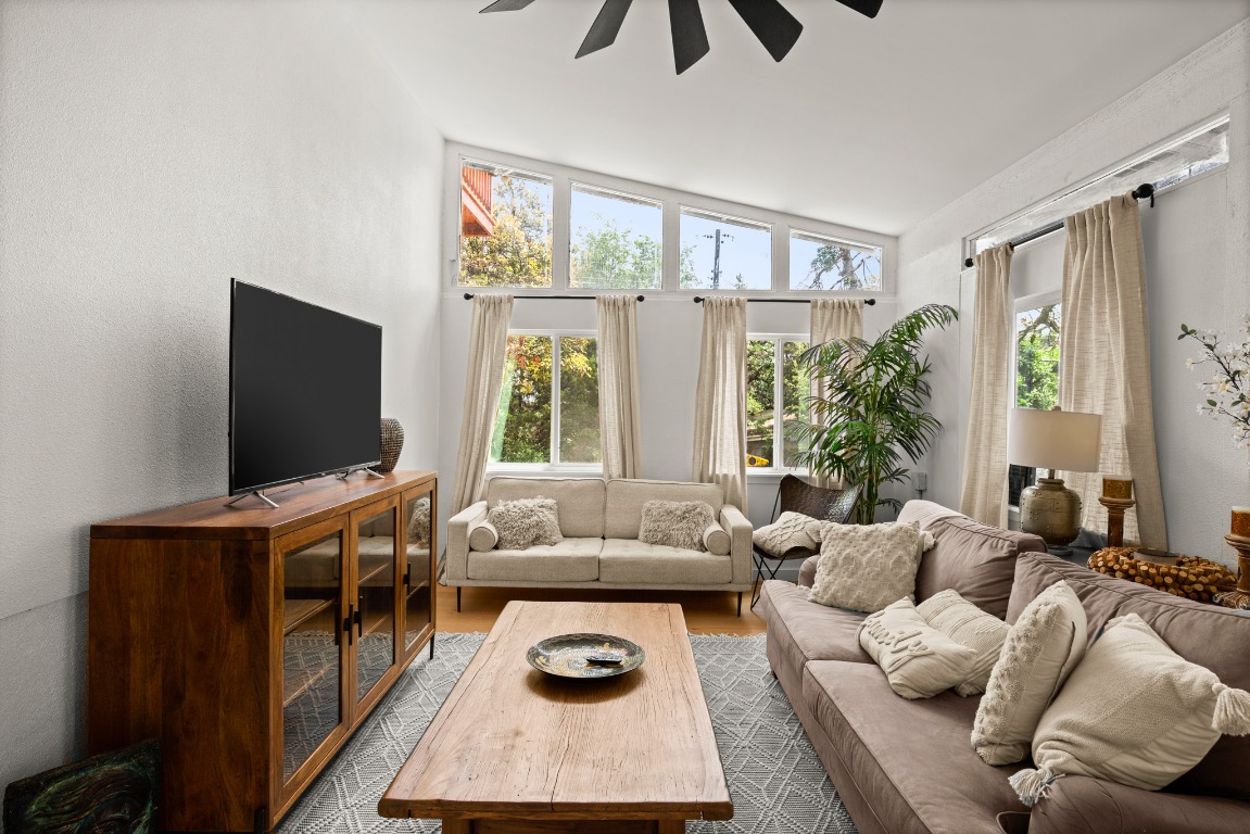 3904 Highland Drive Austin, TX 78734 - Photo 23 of 37 Living area featuring ceiling fan, lofted ceiling, and wood finished floors