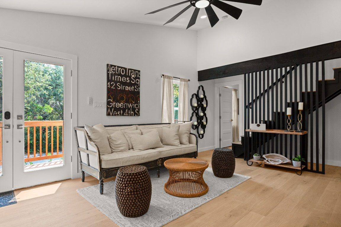 3904 Highland Drive Austin, TX 78734 - Photo 5 of 37 Living room featuring light wood-style flooring, ceiling fan, stairway, and a towering ceiling