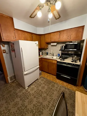 a kitchen with a refrigerator and a sink